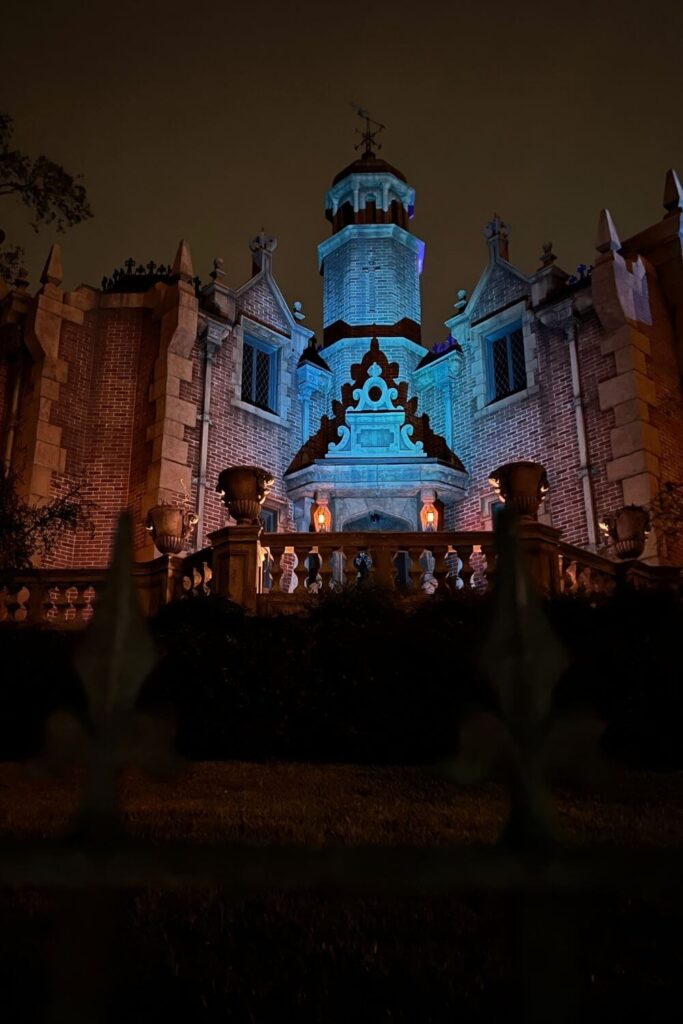 Photo of the Haunted Mansion building at night.