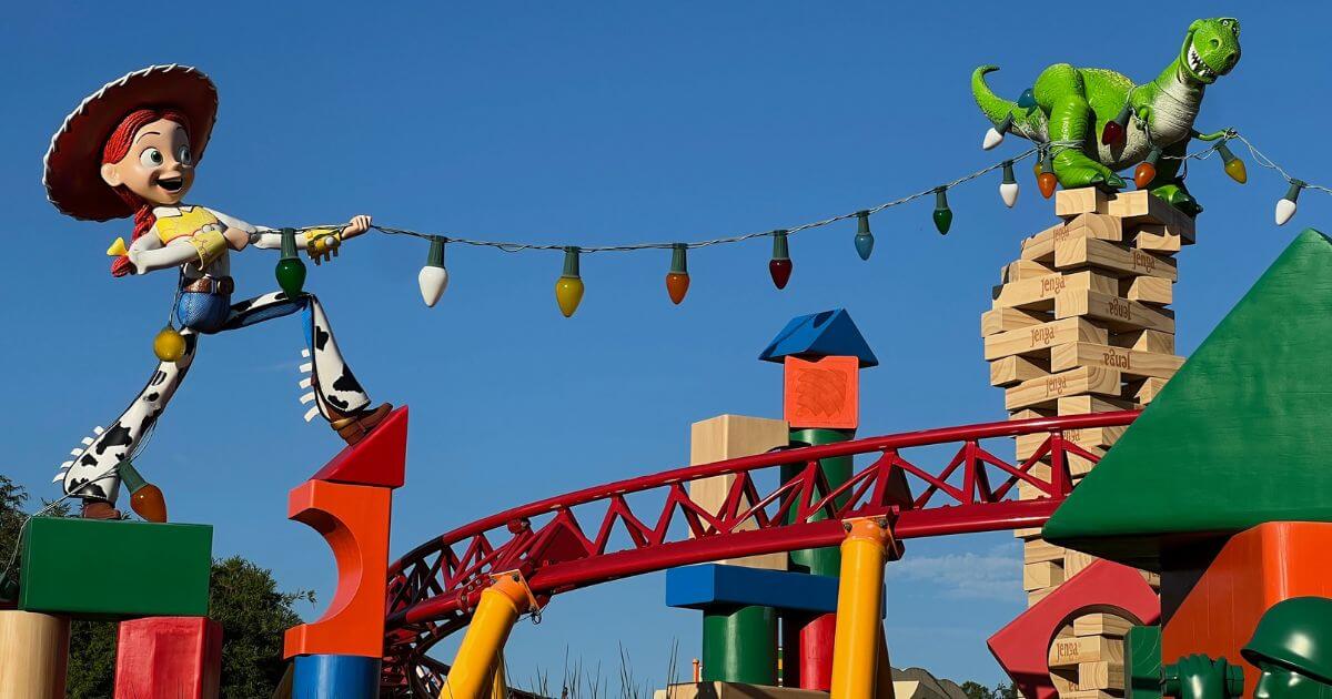 Photo of Jessie and Rex stringing up lights above Slinky Dog Dash in Toy Story Land at Hollywood Studios.