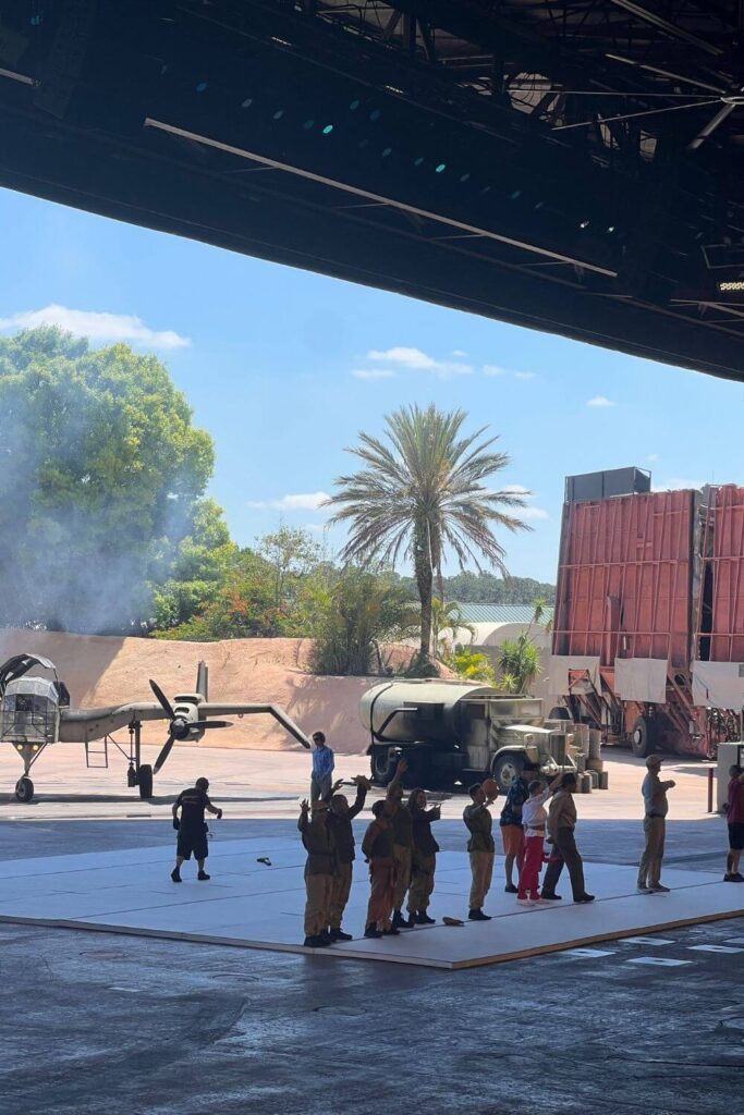 Photo of the cast of the Indiana Jones Stunt Spectacular show, waving to guests at the end of the show.
