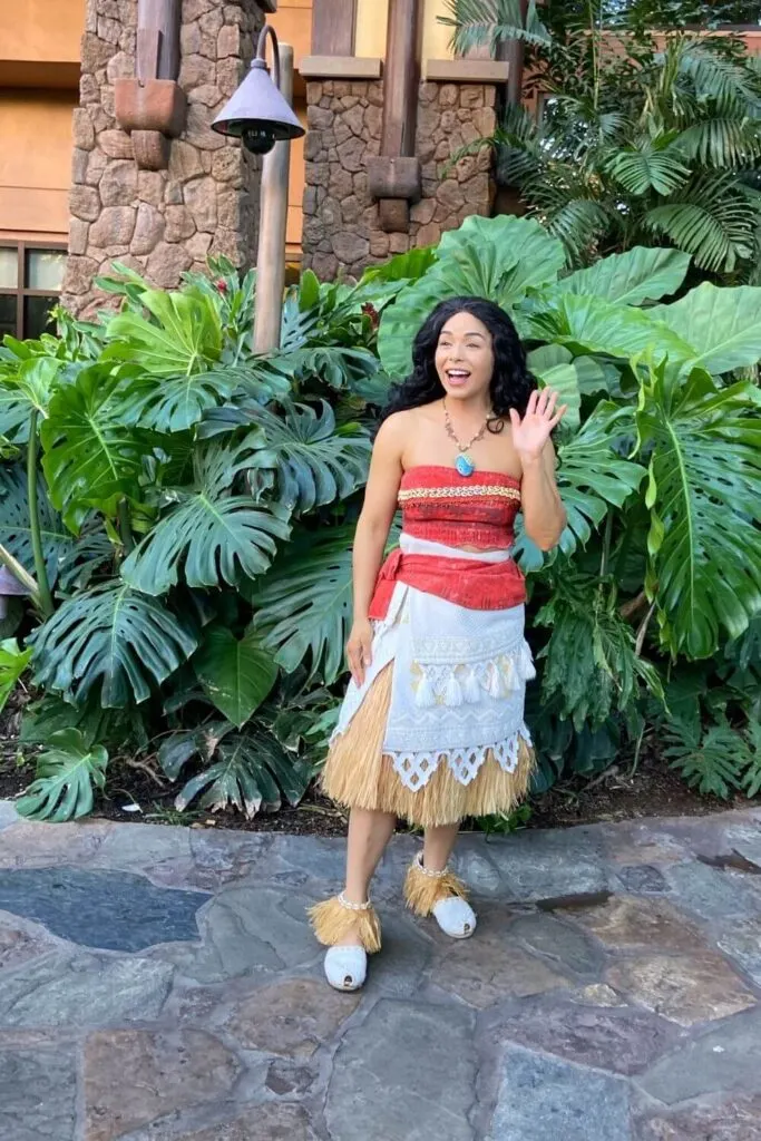 Photo of Moana in the pool area at Aulani, waving to guests.