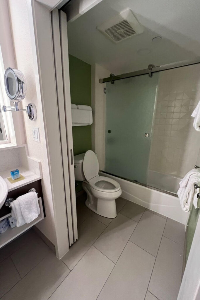 Photo of a typical shower and toilet in a guest room at Disney's All-Star Sports Resort.