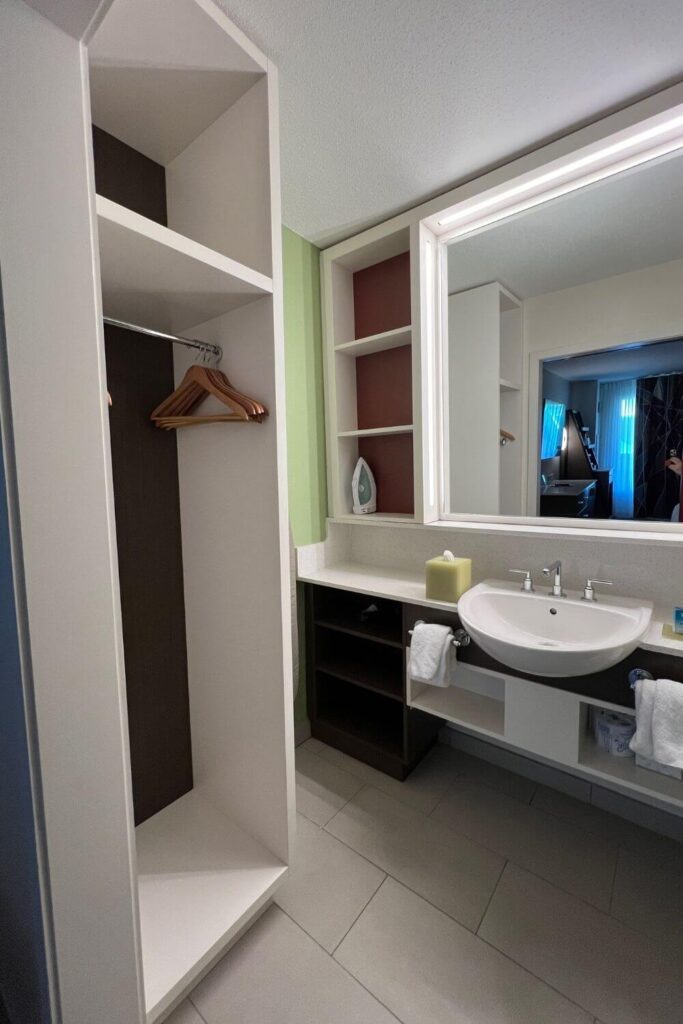 Photo of the closet and sink area in a guest room at Disney's All-Star Sports Resort.