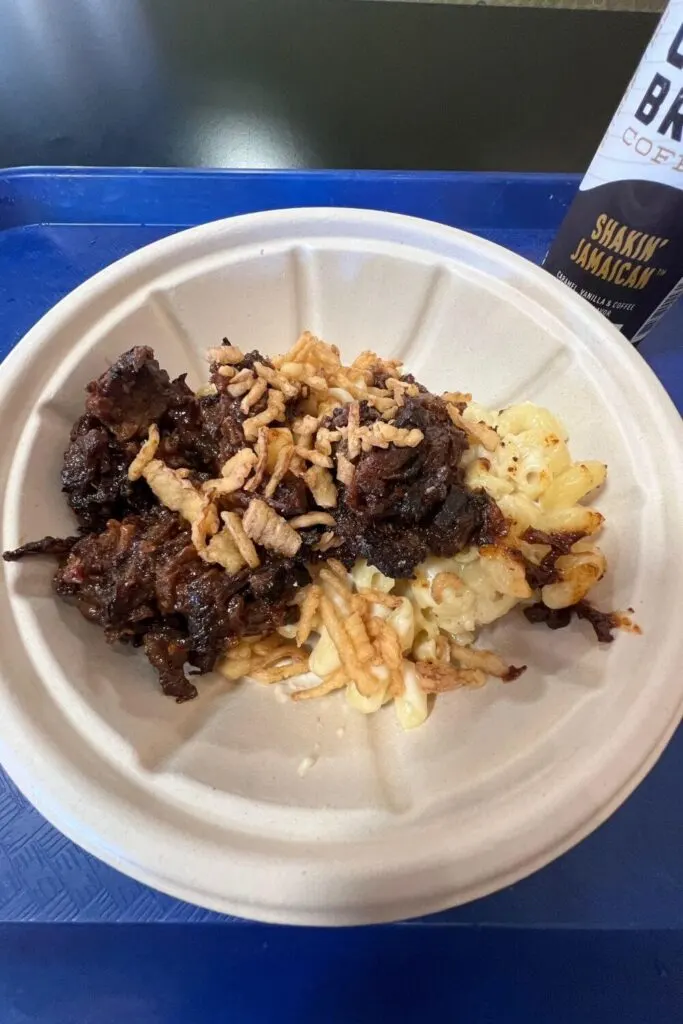 Photo of a bowl of barbecued beef mac n cheese with a can of Joffrey's Shakin' Jamaican cold brew coffee.