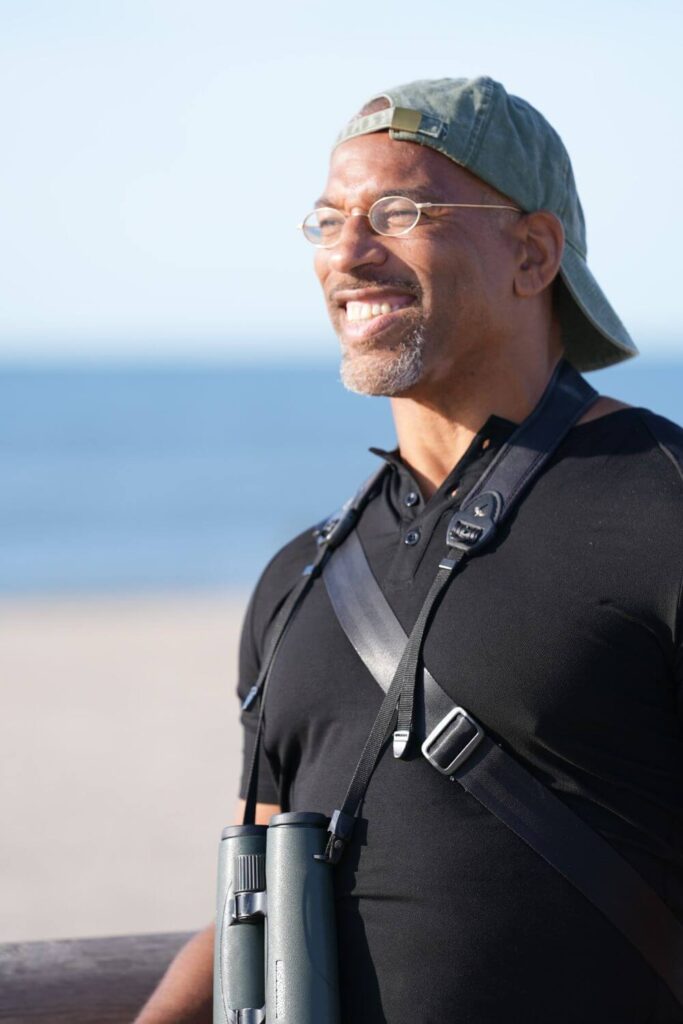 Christian Cooper surveys the beach at Fort Tilden in the National Geographic show, Extraordinary Birder with Christian Cooper.