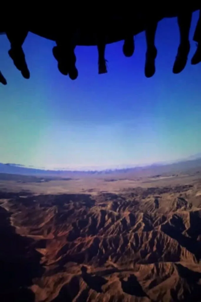 Photo of feet dangling above a screen during the ride Soarin' Over California.