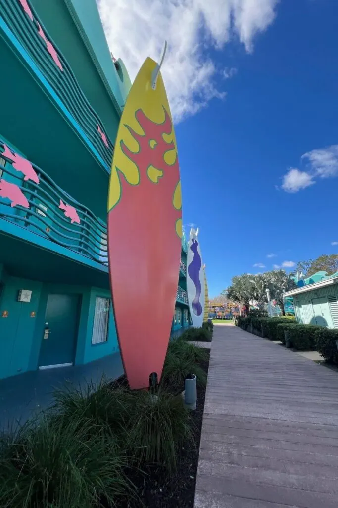 Photo of a hotel building with 3-story tall surfboards adorned on the outside.