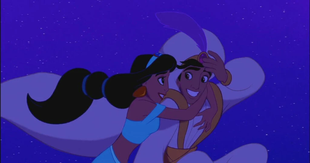 Photo of Princess Jasmine hugging Aladdin as they fly on a magic carpet.