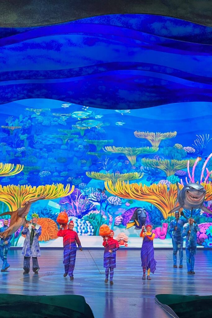 Photo of the encore scene from the Finding Nemo show at Animal Kingdom, with all the main actors and puppets on the stage.