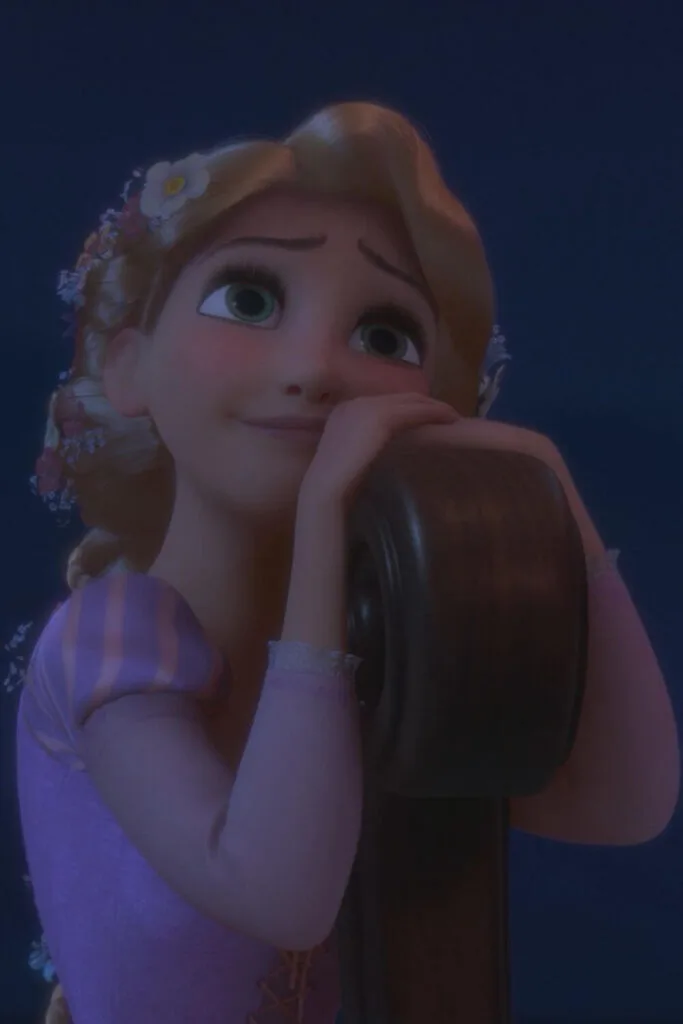 Closeup photo of Rapunzel in the animated Disney film, Tangled, with a serene look on her face.
