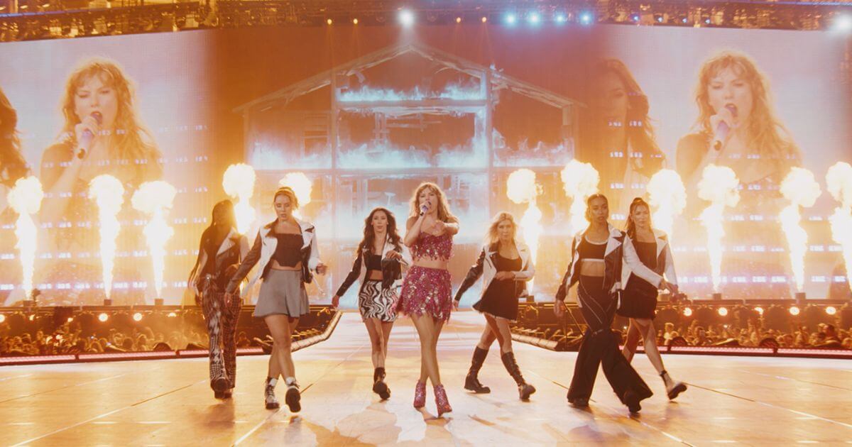 Photo of Taylor Swift and 6 backup dancers performing a song from her hit album, 1989, during the Eras Tour.