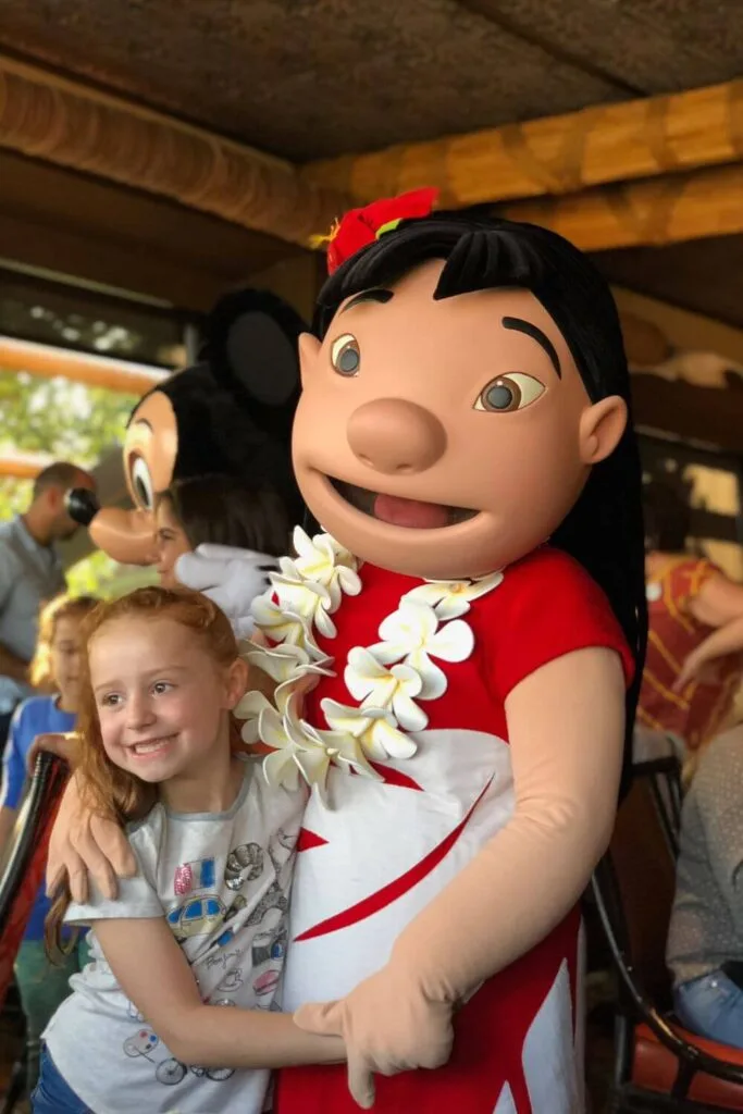 Photo of a young girl hugging Lilo at the Ohana Best Friends character breakfast at the Polynesian Resort.