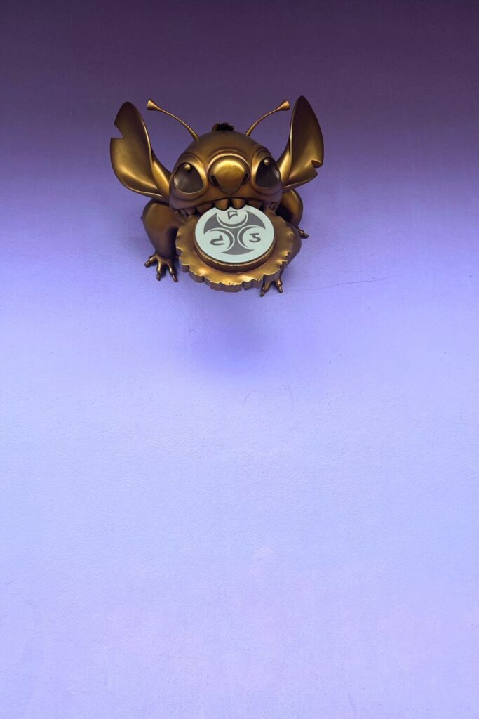 Photo of the hidden golden Stitch statue at Magic Kingdom's Tomorrowland.