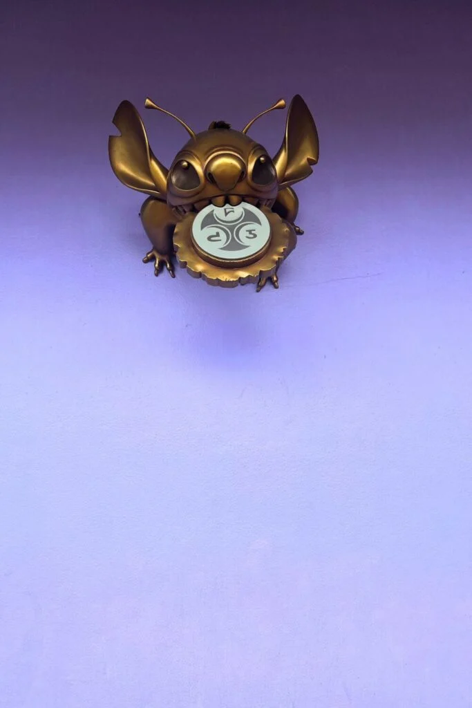 Photo of the hidden golden Stitch statue at Magic Kingdom's Tomorrowland.