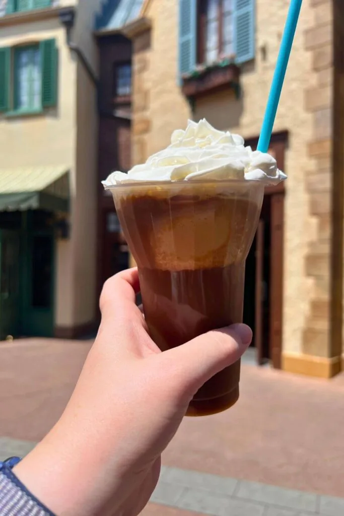 Photo of a Cafe Glace, an iced cappucino with a scoop of caramel fluer de sel ice cream, topped with whipped cream.