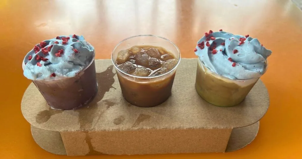 Photo of the cold brew flight from Satuli Canteen at Animal Kingdom. Clockwise, L-R: Ube Cold Brew, Classic Cold Brew, and Matcha Cold Brew