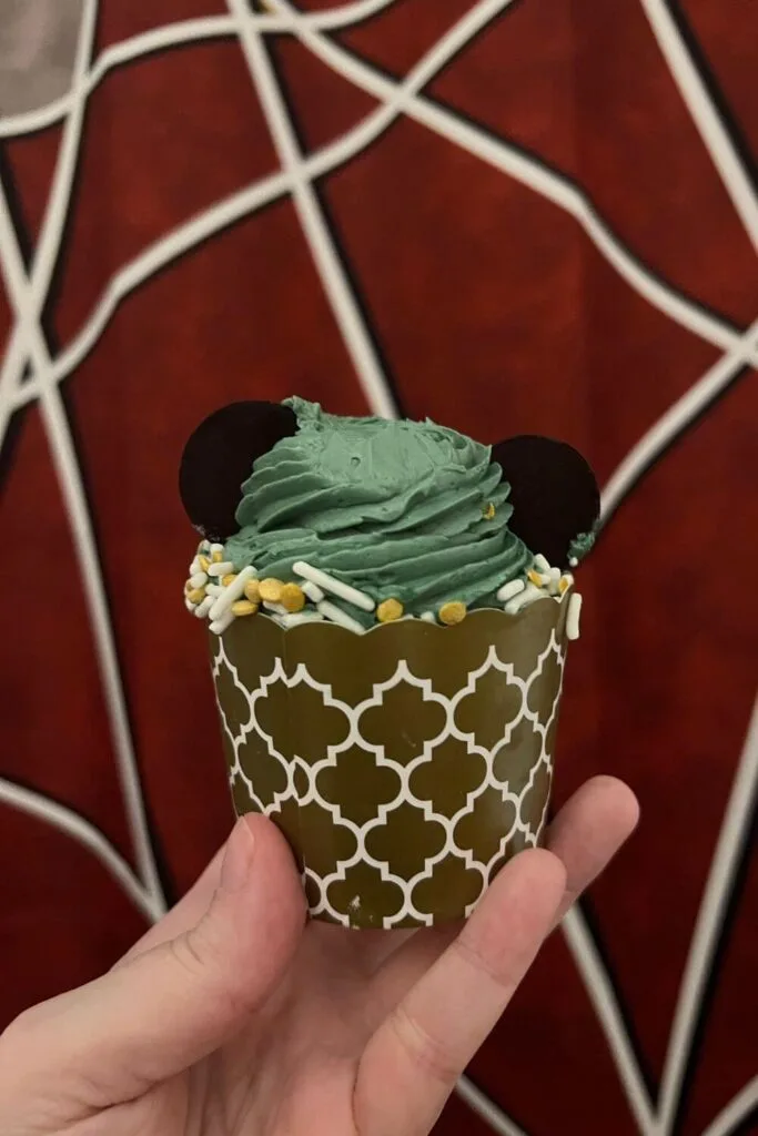Photo of the Earl Gray cupcake from Hollywood Studios with blue-gray frosting and chocolate coins to form a Mickey head.