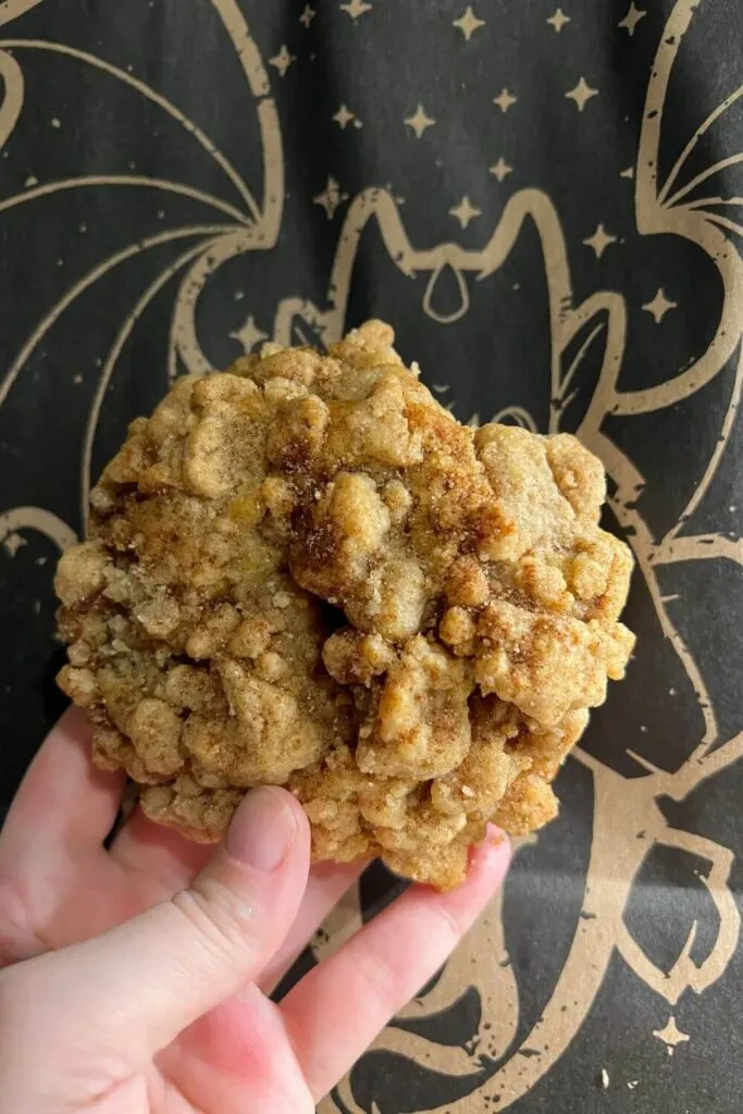 Closeup of a coffee cake cookie from Gideon's Bakehouse with a bag from the bakery in the background.