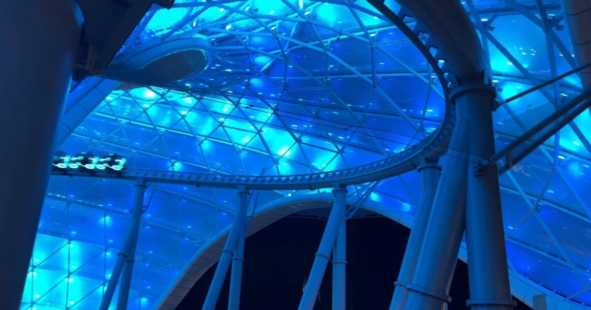Photo of a line of light cycles zooming by on TRON roller coaster at Magic Kingdom.