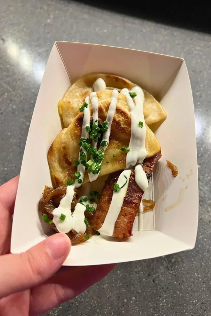 Photo of a basket of pierogis and kielbasa from Epcot's Festival Favorites snack stop.