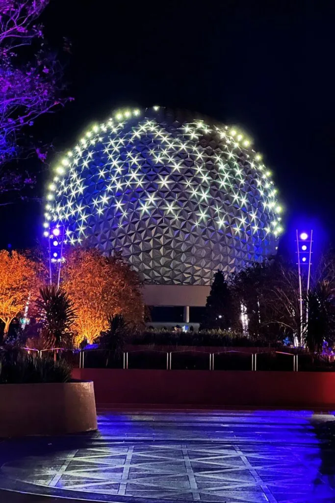 Photo of Spaceship Earth lit up with star-like lights at Epcot.