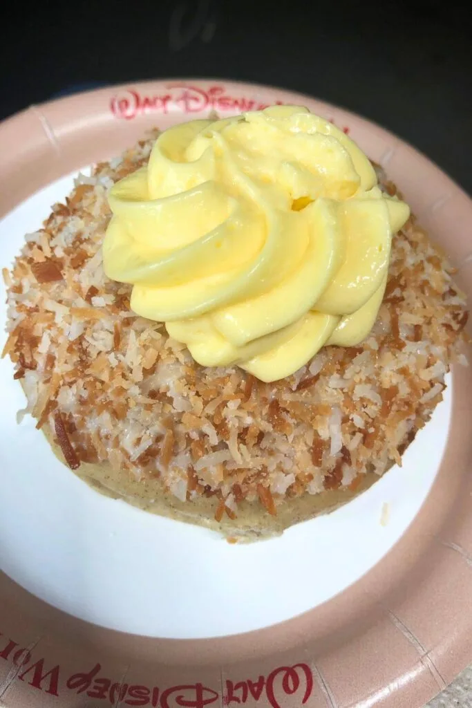 Photo of school bread, a coconut covered sweet bun with custard on top.
